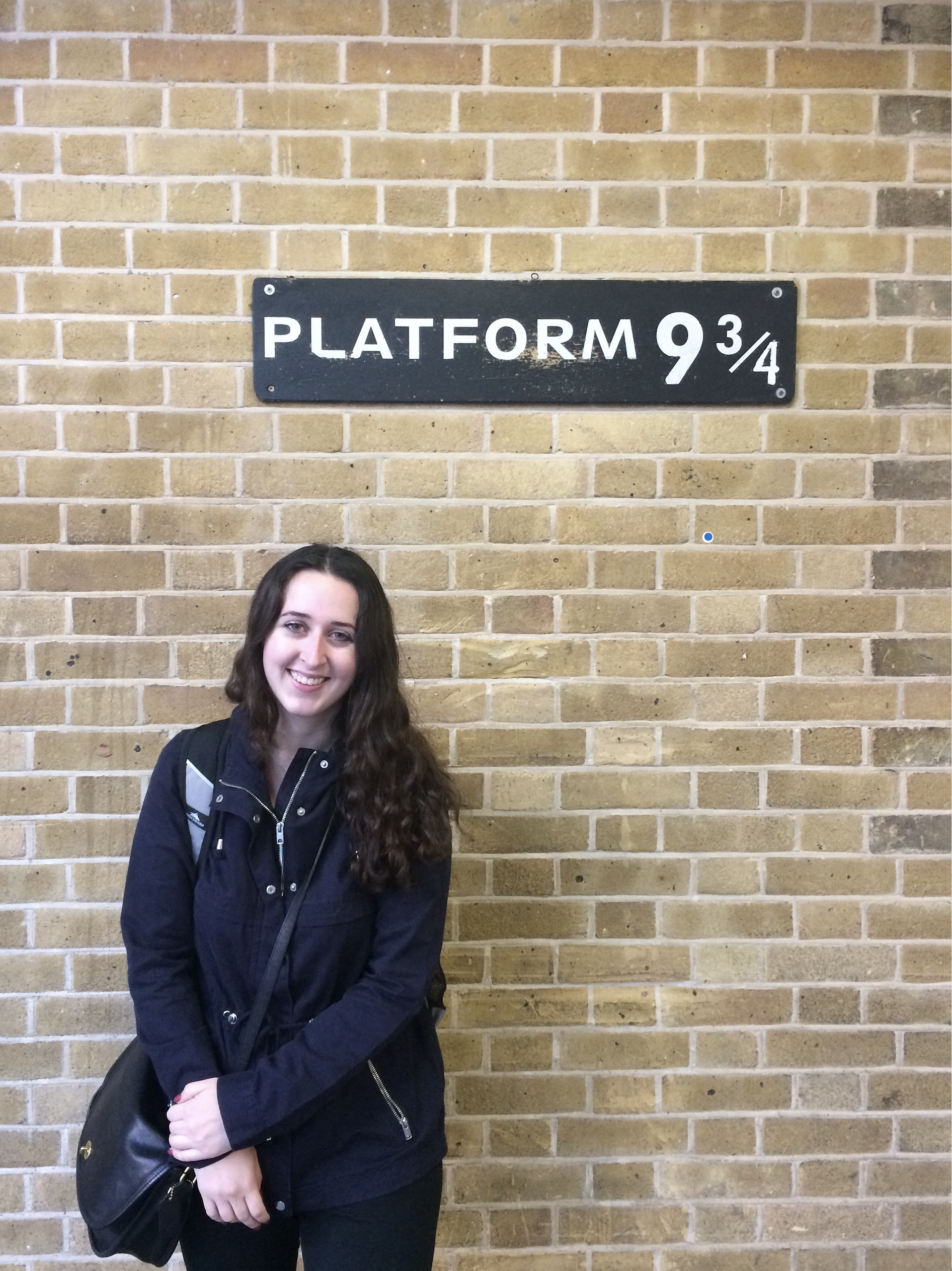 Rachel Carter standing in front of Platform 9 3/4.